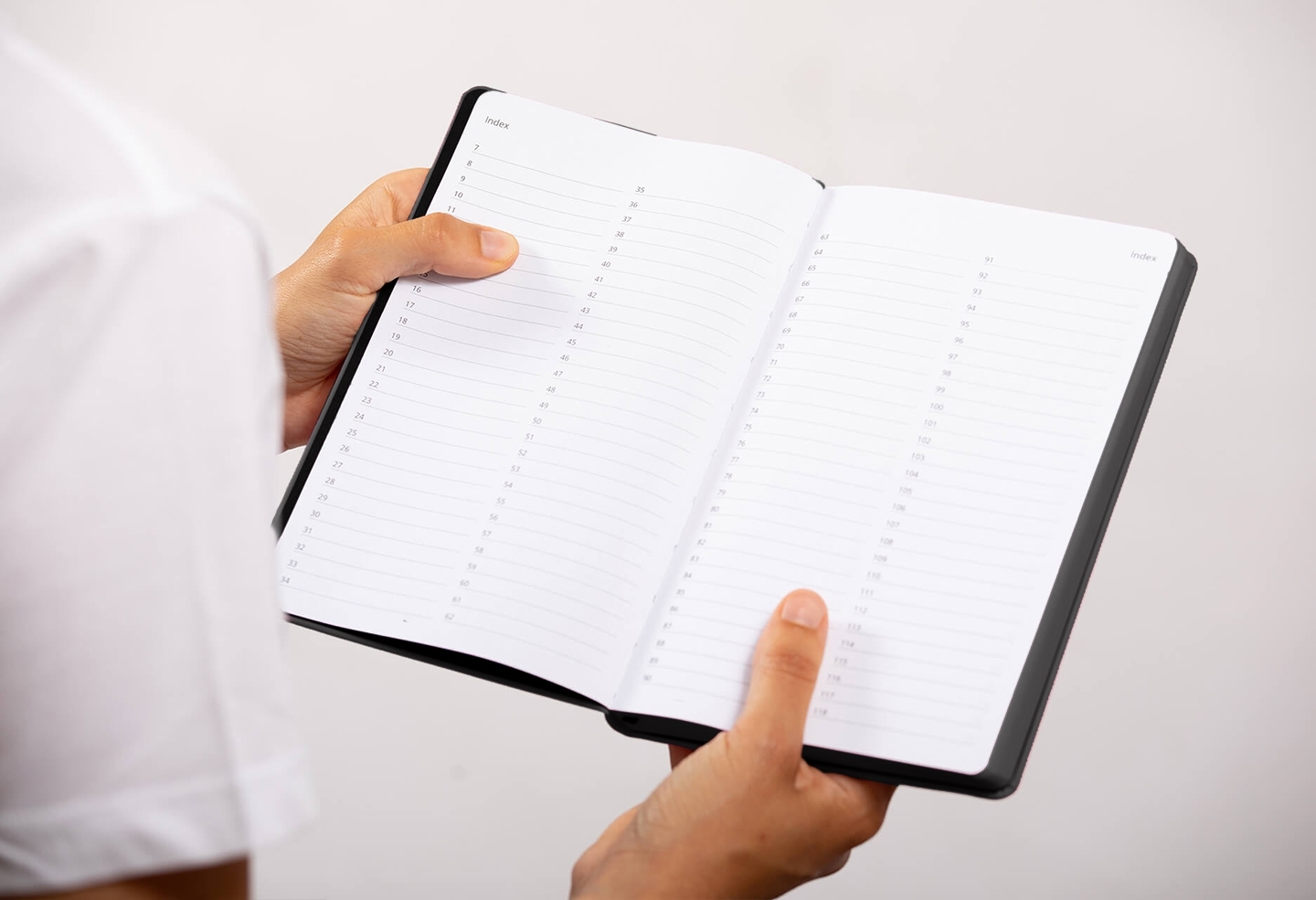 Carnet de note infirmière ouvert tenu en main par une professionnelle de santé – coloris noir