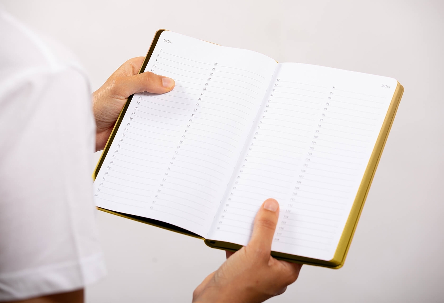Carnet de note infirmière ouvert tenu en main par une professionnelle de santé – coloris or