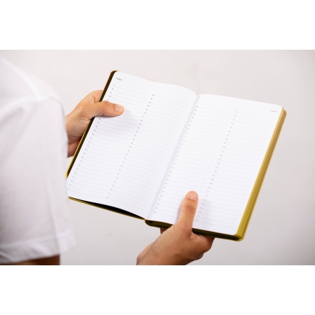 Carnet de note infirmière ouvert tenu en main par une professionnelle de santé – coloris or